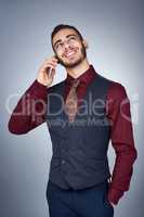 Aim high, achieve your dreams by going after it. Studio shot of a handsome young businessman on a call against a grey background.