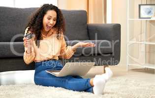 I got extra discount with my bank. Shot of a woman holding a credit card while using her laptop.