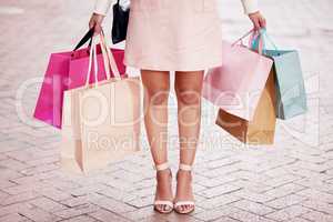I love the smell of a shopping spree. an unrecognizable woman out shopping in the city.