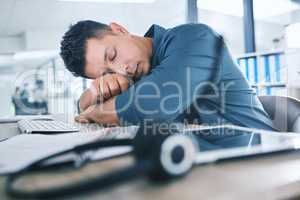 One hispanic call centre telemarketing agent sleeping in an office. Businessman feeling overworked, tired and demotivated while operating helpdesk. Lazy consultant slacking and ignoring customers by taking a nap. Burnout and stress in the workplace