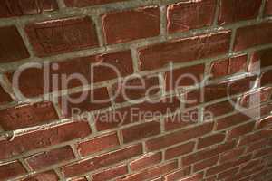 Above closeup of a wall of red brick still life. Hard solid building material with rough texture on a building in town, city or house. Concrete surface with cement lining to keep a structure intact