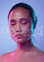 Promise of the night. Cropped shot of an attractive young woman posing in studio against a purple background.