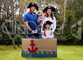 In my family, crazy is relative. All of them. a family dressed up like pirates outside in the yard.