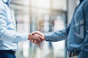 Great partnerships start with a firm handshake. Shot of two unrecognizable businesspeople shaking hands in an office at work.