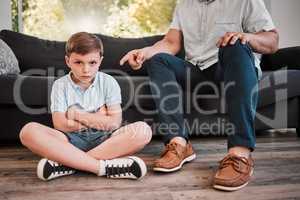 Throw some perm on your attitude. Shot of a father losing his patience with his son at home.