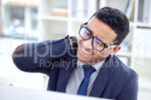 Listen to your body. a businessman experiencing discomfort while sitting at his desk.