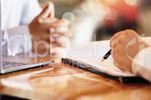 Filling out the paperwork. an unrecognizable car salesman talking to a customer in his office at the car dealership.