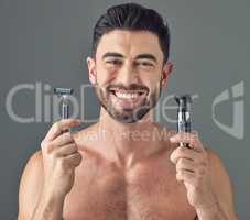 Its important to know whats better for your skin. Studio shot of a man holding up a disposable razor and an electric shaver.