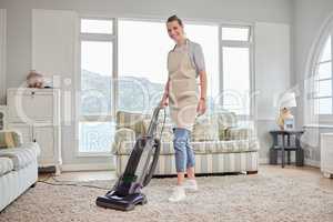 Once you clean your space, youll clear your mind. Portrait of a young woman vacuuming a carpet in the lounge at home.