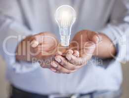What a clever idea. Closeup shot of an unrecognisable businessman with a lightbulb hovering in his hands.