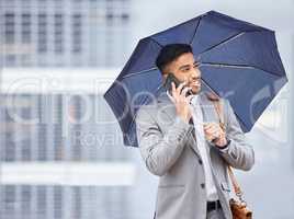 Rain, hail or shine - success is mine. a young businessman holding an umbrella while talking on a cellphone on a rainy day in the city.