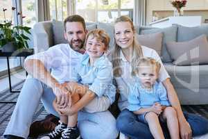 Make time for your loved ones. Cropped portrait of an affectionate mature couple and their kids sitting in the living room at home.