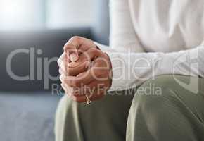 Picking skin is a typical symptom of anxiety. an unrecognisable woman sitting alone and feeling anxious during therapy.