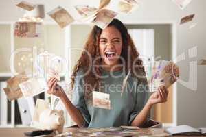 One happy young mixed race woman feeling rich and successful while throwing money at home. Excited hispanic celebrating after saving and budgeting finances. Planning for the future or win a lottery