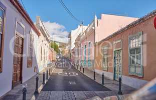 Historical city street view of residential houses in small and narrow alley or road in tropical Santa Cruz, La Palma, Spain. Village view of vibrant buildings in popular tourism destination overseas