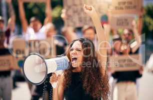 The world is not enough. a young woman shouting into a loudhailer during a protest.