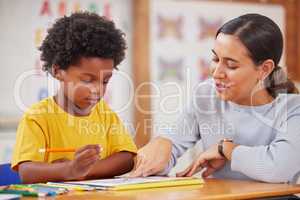 I love the colours youve used here. a female teacher assisting a preschool learner in her class.