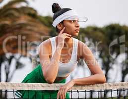 I hope I win today. a sporty young woman leaning over the tennis net.