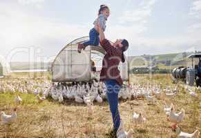 Born and raised on a farm. a woman bonding with her daughter on a poultry farm.