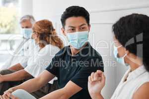 Covid will be a hot topic for years to come. a group of people wearing face masks while sitting in a queue.
