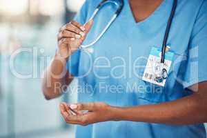 Closeup hands of african american woman nurse standing and holding copyspace in the hospital. Endorsing your lifestyle products. Use this product daily. Health and safety in the field of medicine