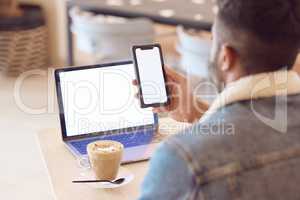 Setting my own pace of work. a man using his smartphone and laptop to work in a coffee shop while enjoying a cup of coffee.