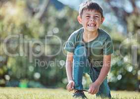 Little boy are such free little creatures. an adorable little boy tying his shoelaces outside.