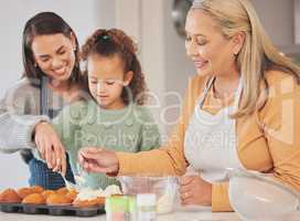 These are perfect for my schools bake sale. Shot of a little girl baking with her mother and grandmother at home.