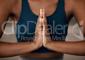 Control your chaos with a little meditating. Closeup shot of an unrecognisable woman meditating in a gym.