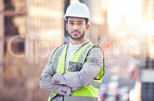 Ready to get started. Cropped portrait of a handsome male construction worker standing with his arms folded on a building site.