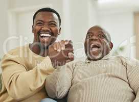 Family means nobody gets left behind or forgotten. a father and son laughing in the lounge.