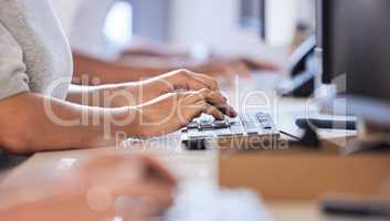 Never keep customers waiting for replies. Closeups shot of an unrecognisable businesswoman typing on a computer keyboard while working alongside her colleagues in an office.