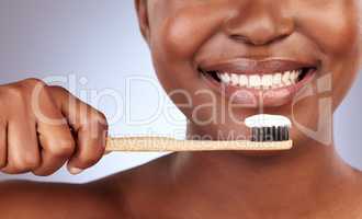Brush them religiously. Studio shot of a beautiful young woman brushing her teeth.
