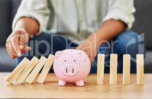 Setting a goal is not the main thing. a unrecognizable man playing with blocks and a piggy bank on a table.
