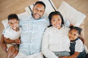 Family is a blessing. a family laying on the floor at home.