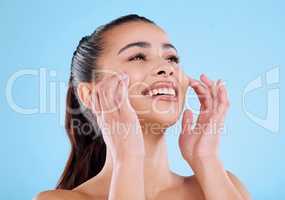 Perfect skin takes time and effort. Studio shot of an attractive young woman posing against a blue background.