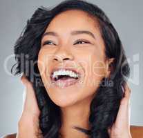 Theres a sparkle to her beauty. Studio shot of an attractive young woman posing against a grey background.