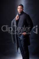 Clothing can do wonders for your confidence. Studio portrait of a handsome and fashionable young man posing against a dark background.