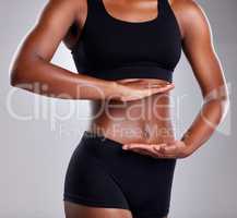 What you put inside affects your whole body. Studio shot of an unrecognisable woman framing her stomach against a grey background.