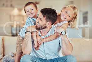 Father playing with his children. Brother and sister bonding with their dad. Dad giving his kids a piggyback ride. Happy caucasian family playing at home. Excited father carrying his children