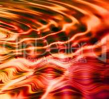 Abstract red and orange water ripple effect with vibrant liquid making a reflection of warm colors with wavy design. Wallpaper background of creative CGI digital artwork with colorful bright pattern