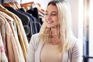 Looking for the latest and greatest in the fashion world. a young woman shopping in a retail store.