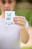 Equality is the soul of liberty. a unrecognizable woman holding a card in protest in a park.