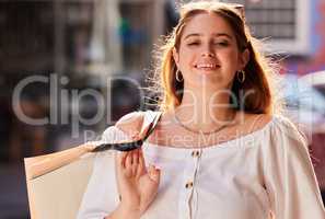 I managed to get everything I wanted to. Cropped portrait of an attractive young woman carrying her bags while on a shopping spree in the city.