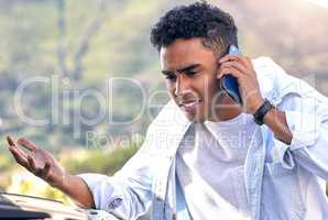 I dont know what happened... a handsome young man on the phone with roadside assistance after suffering a vehicle breakdown.