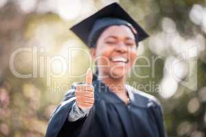 Wishing you the best of luck for the future. Closeup shot of a young woman showing thumbs up on graduation day.