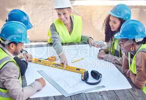 Making sure everything goes according to plan. a group of construction workers discussing blueprints while working on a building site.