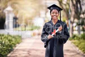 Success is something I know I can achieve in life. Portrait of a young woman holding her diploma on graduation day.