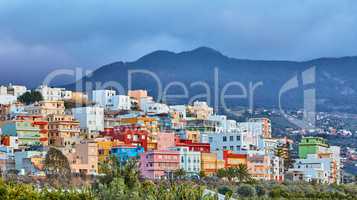 Colorful buildings in Santa Cruz de La Palma with copy space. Beautiful cityscape with bright colors mountains and overcast clouds. A vibrant holiday or vacation destination on the hillside