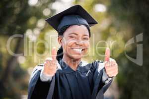 If I can do it, so can you. Portrait of a young woman showing thumbs up on graduation day.